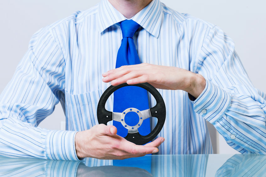 Man holding car steering wheel